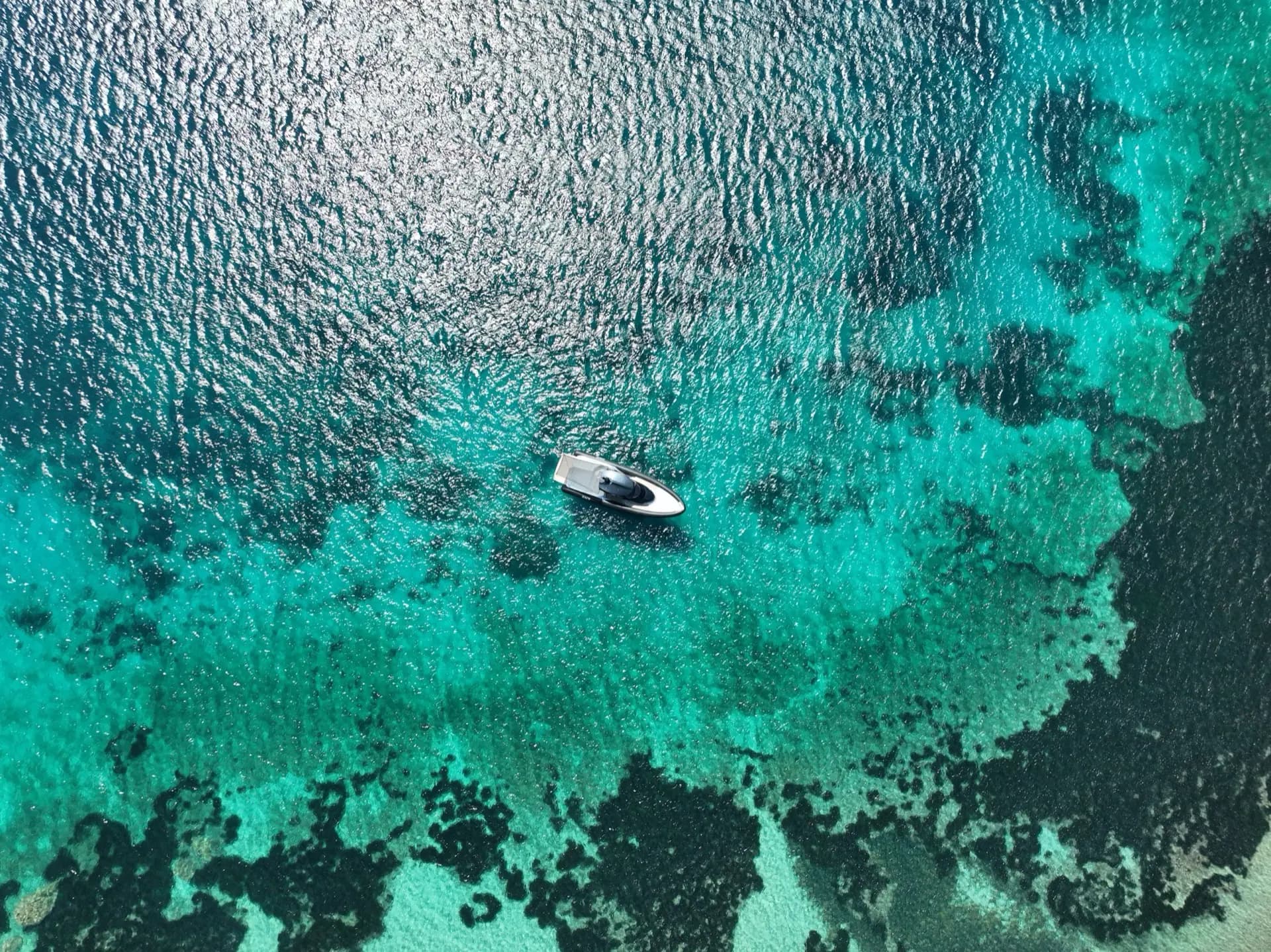 High-altitude drone view of SACS Strider 15 anchored over Sardinian reef