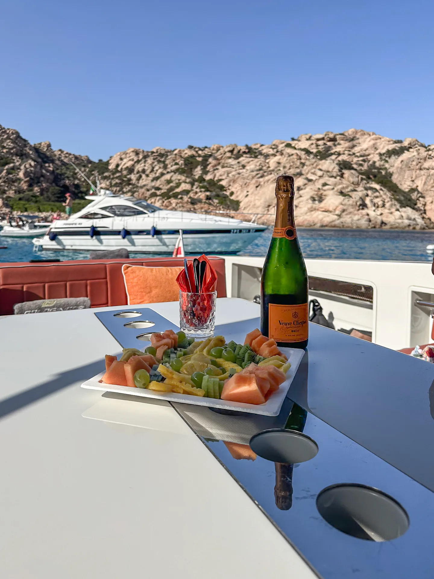 Piatto di frutta con Veuve Clicquot nell'arcipelago della Maddalena