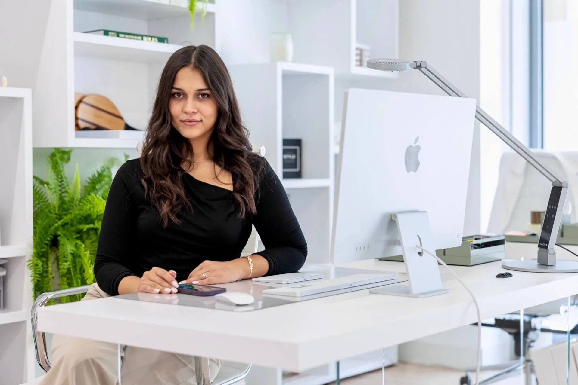 Kristina from MareFun at her workspace with design tools and computer