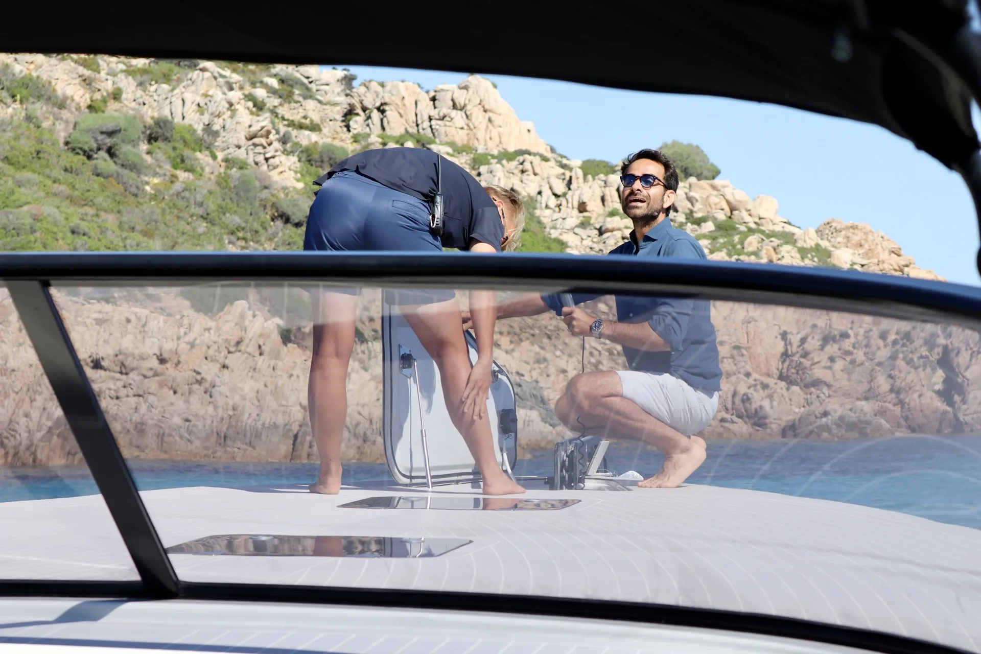 Marco from MareFun assisting a guest on deck along the Sardinian coast