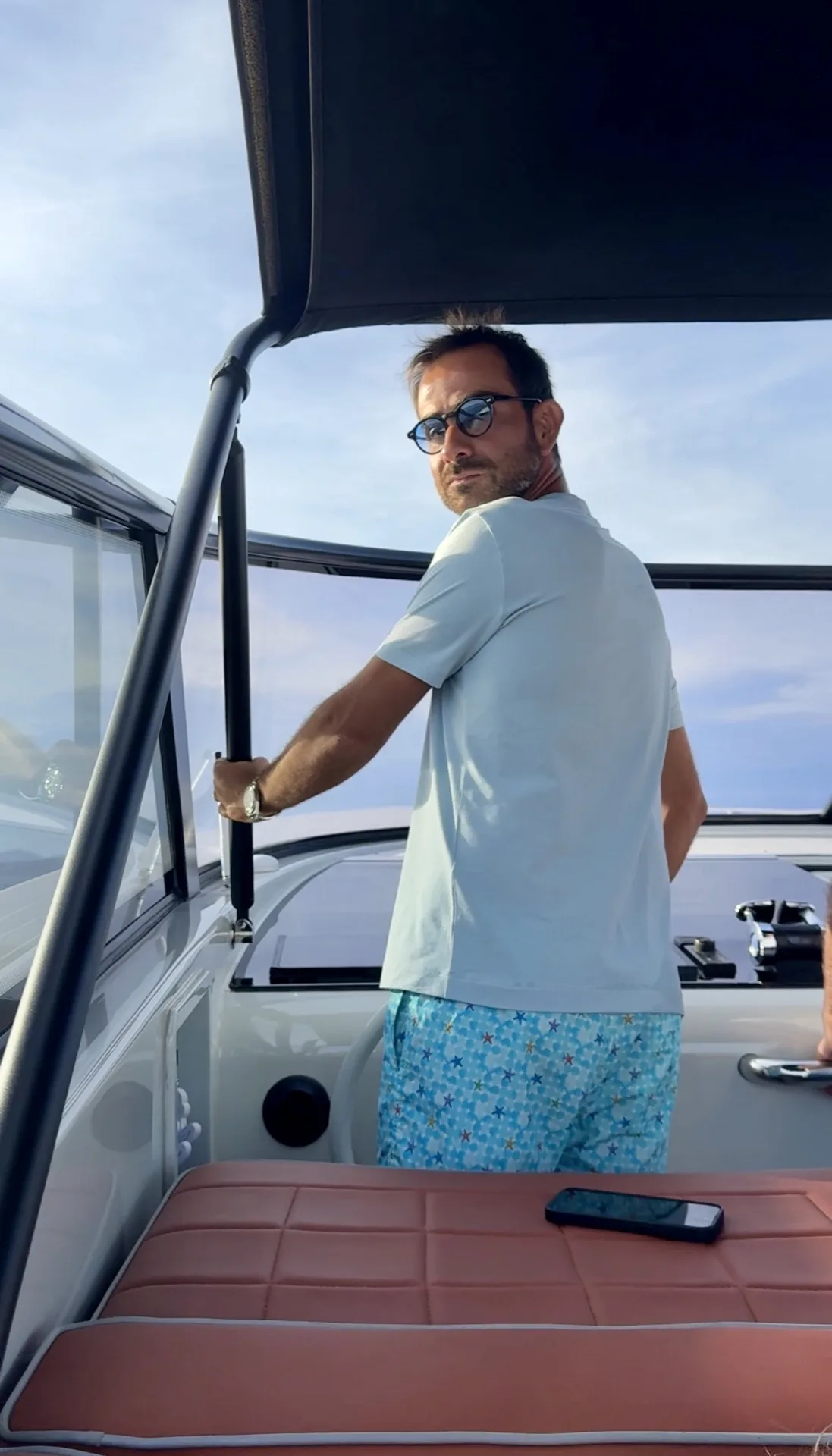 Marco captaining a MareFun charter boat at sunset off the coast of Sardinia