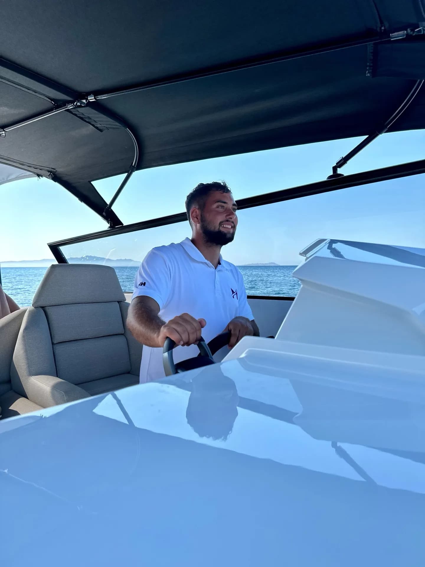 Lorenzo, MareFun captain, steering a charter yacht on the Sardinian sea