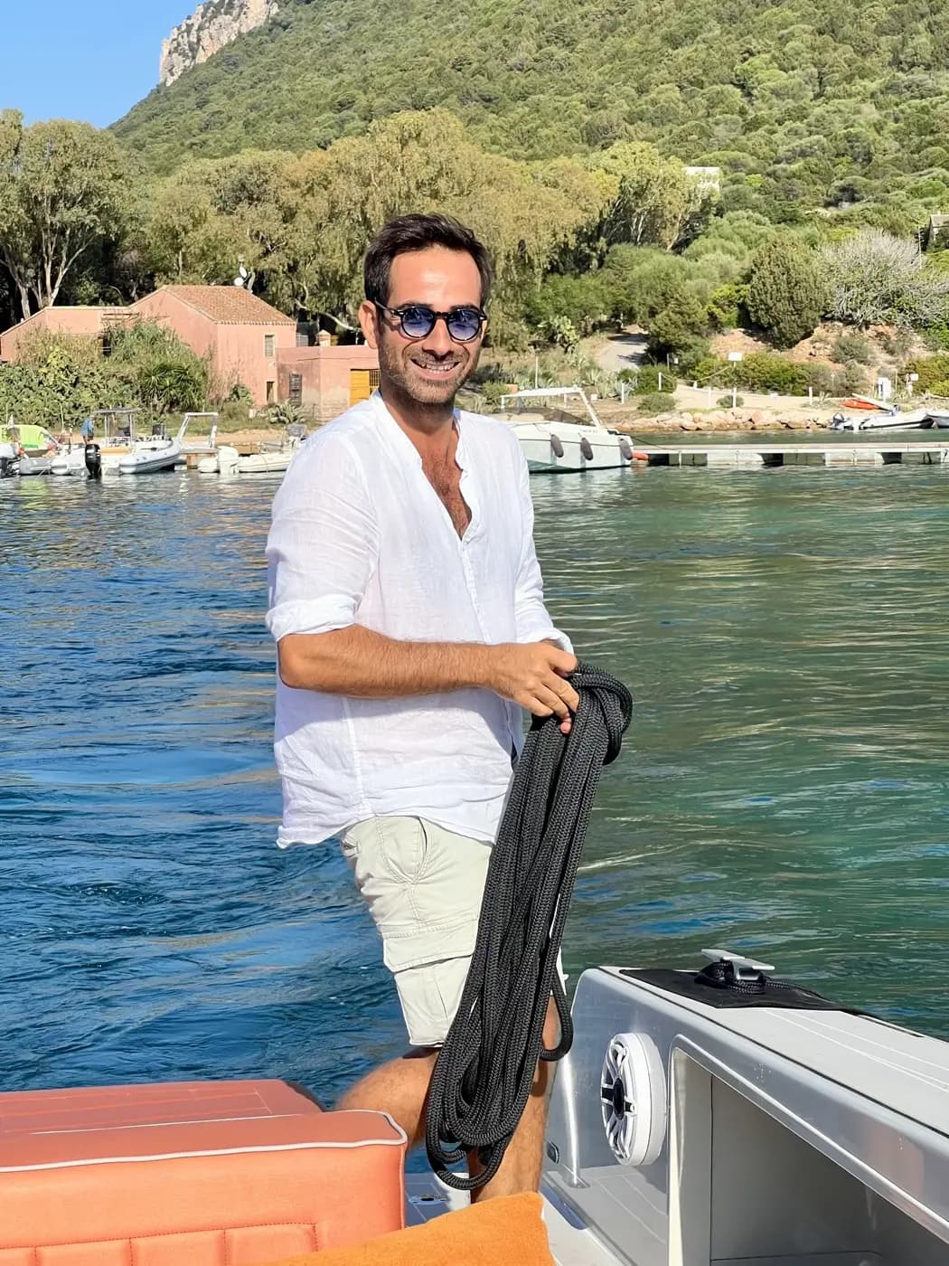 Marco, CEO and founder of MareFun, holding dock lines on a charter boat in Sardinia